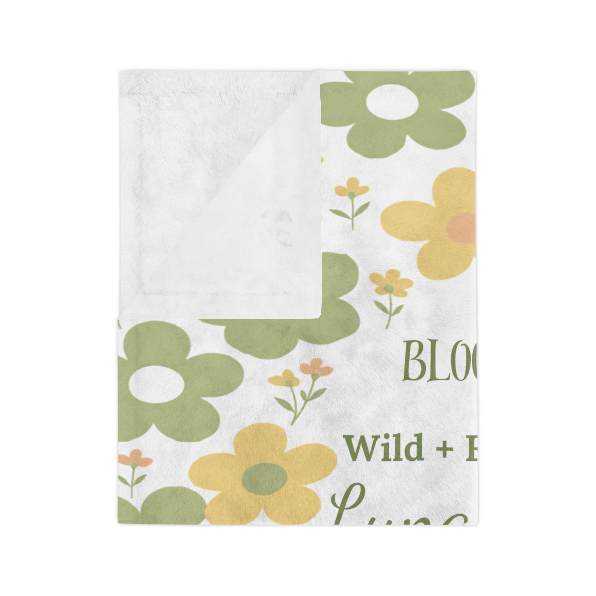 Folded velveteen microfiber baby blanket showing soft floral print and plush white reverse side